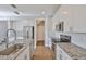 Modern kitchen features white cabinets, stainless steel appliances, and granite countertops, creating a sleek and functional cooking space at 6619 S Manhattan Ave # 1, Tampa, FL 33616