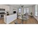 Open-concept living room with a modern kitchen, dining area, and sliding glass doors at 6619 S Manhattan Ave # 1, Tampa, FL 33616