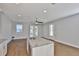 Open floor plan with a kitchen island, white cabinetry, and access to the outside patio at 6619 S Manhattan Ave # 1, Tampa, FL 33616