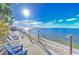 Relaxing scene featuring deck chairs overlooking the tranquil bay, bridge in the distance, and blue skies at 6619 S Manhattan Ave # 1, Tampa, FL 33616