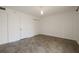 A simple bedroom with neutral walls, tile flooring, and two closets for ample storage at 6960 20Th N Ave # 203B, St Petersburg, FL 33710