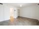 A simple bedroom with neutral walls, tile flooring, and an open closet for ample storage at 6960 20Th N Ave # 203B, St Petersburg, FL 33710