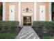 Welcoming building entrance with a classic lamp and mature landscaping at 6960 20Th N Ave # 203B, St Petersburg, FL 33710