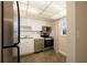 Efficient kitchen features stainless steel appliances and bright white cabinetry at 6960 20Th N Ave # 203B, St Petersburg, FL 33710
