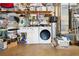 Laundry room features a washer, dryer, and water heater with shelving for storage in the basement at 708 Westwood Cir, Brandon, FL 33511