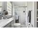 Modern bathroom with a glass walk-in shower, white marble tile, and updated fixtures at 708 Westwood Cir, Brandon, FL 33511