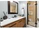 Stylish bathroom featuring wood vanity with a modern faucet and a tiled shower at 708 Westwood Cir, Brandon, FL 33511