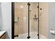 Tiled shower with glass door and updated fixtures in a light blue painted bathroom at 708 Westwood Cir, Brandon, FL 33511