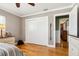 Neutral bedroom showcasing hardwood floors, closet with sliding doors, and white painted trim at 708 Westwood Cir, Brandon, FL 33511