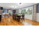 Elegant dining room with hardwood floors, large window, and classic furnishings creating a warm ambiance at 708 Westwood Cir, Brandon, FL 33511