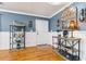 Stylish entryway featuring hardwood floors, soft blue walls, and decorative shelves with elegant decor at 708 Westwood Cir, Brandon, FL 33511