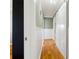 Long hallway with hardwood floors and unique doors with black accents and neutral paint at 708 Westwood Cir, Brandon, FL 33511