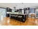 Expansive kitchen island with seating, modern lighting, dark cabinetry, and stainless steel appliances at 708 Westwood Cir, Brandon, FL 33511