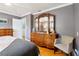 Spacious main bedroom features hardwood floors, a large dresser with mirrors, and a calming gray color scheme at 708 Westwood Cir, Brandon, FL 33511