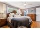 Relaxing main bedroom featuring hardwood floors, a decorative headboard, and a view of the ensuite bathroom at 708 Westwood Cir, Brandon, FL 33511