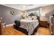 Comfortable main bedroom featuring hardwood floors, a decorative headboard, and ample natural light at 708 Westwood Cir, Brandon, FL 33511