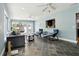 Bright sunroom with tile floors, multiple seating options, and a view into the open kitchen at 708 Westwood Cir, Brandon, FL 33511