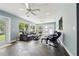 Bright sunroom with tile floors, multiple seating options, and large windows offering natural light and backyard views at 708 Westwood Cir, Brandon, FL 33511