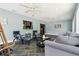 Open-concept sunroom with tile floors, casual seating arrangements, and a pass-through to the kitchen at 708 Westwood Cir, Brandon, FL 33511