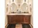 Bathroom with double sink vanity, granite counters, and dark wood cabinets at 7312 Nova Cir, Tampa, FL 33634