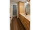 Bathroom with wood cabinets, drawers, sink, mirror, and walk-in shower at 7312 Nova Cir, Tampa, FL 33634