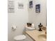 Cozy bathroom with a toilet, sink, tan countertop, and decorative wall art at 7312 Nova Cir, Tampa, FL 33634