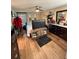Bedroom with wood floors, window with blinds, dark accents, and mounted TV at 7312 Nova Cir, Tampa, FL 33634