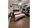 Bedroom with dark accents, wood floors, shelving and window with blinds at 7312 Nova Cir, Tampa, FL 33634