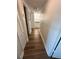 Hallway with hardwood floors, white walls, and white closet door at 7312 Nova Cir, Tampa, FL 33634