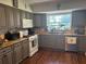 Well-lit kitchen with gray cabinets, granite countertops, and modern appliances at 7312 Nova Cir, Tampa, FL 33634