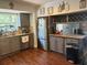 Charming kitchen with gray cabinets, stainless steel appliances, granite counters, and a wine rack above breakfast bar at 7312 Nova Cir, Tampa, FL 33634