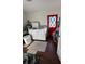 Laundry room with white washer and dryer, red back door, and wood floors at 7312 Nova Cir, Tampa, FL 33634