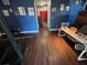 Spacious living room with wood floors, bright blue walls, and a red front door at 7312 Nova Cir, Tampa, FL 33634