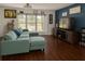 Comfortable living room with large windows, plush sofa, and modern entertainment center at 7312 Nova Cir, Tampa, FL 33634