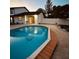 Backyard pool with hardscape decking and view of the back of the house at 7312 Nova Cir, Tampa, FL 33634