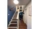 Inviting stairway featuring wooden steps and dark blue walls, leading to the upper level at 7312 Nova Cir, Tampa, FL 33634