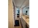 Cozy bathroom with neutral finishes, featuring a shower with curtain, vanity, and an adjacent bedroom at 7834 Treasure Pointe Dr, Port Richey, FL 34668