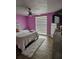 Bright bedroom with wood flooring, fan, and window that lets in natural light at 7834 Treasure Pointe Dr, Port Richey, FL 34668