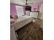 Cozy bedroom featuring wood floors, ceiling fan, and plenty of natural light at 7834 Treasure Pointe Dr, Port Richey, FL 34668