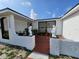 Welcoming entrance with dual angel statues, and mature landscaping leading up to a modern home's entry at 7834 Treasure Pointe Dr, Port Richey, FL 34668