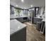 Updated kitchen with stainless steel appliances, ample gray cabinetry, and marble countertops, offering a sleek design at 7834 Treasure Pointe Dr, Port Richey, FL 34668