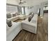 Bright and stylish living room with wood floors, modern sofas, and contemporary decor for elegant living at 7834 Treasure Pointe Dr, Port Richey, FL 34668