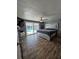 Comfortable primary bedroom with slider door to a screened pool area at 7834 Treasure Pointe Dr, Port Richey, FL 34668