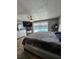 Comfortable primary bedroom with slider door to a screened pool area at 7834 Treasure Pointe Dr, Port Richey, FL 34668