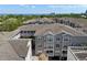 Aerial view of condo buildings with gray exteriors, light-colored roofing, and a water view in the distance at 800 S Dakota Ave # 337, Tampa, FL 33606