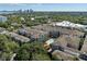 Aerial view of the community with beautiful landscaping, city skyline in the distance, and a pool at 800 S Dakota Ave # 337, Tampa, FL 33606