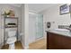 Bathroom with glass door shower, modern toilet, dark cabinets, and granite countertop sink at 800 S Dakota Ave # 337, Tampa, FL 33606