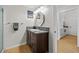 Bathroom view featuring dark cabinets, granite countertop, decorative mirror, and art at 800 S Dakota Ave # 337, Tampa, FL 33606