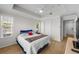 This bedroom offers tray ceilings, a ceiling fan, wood floors, and plenty of natural light from the windows at 800 S Dakota Ave # 337, Tampa, FL 33606