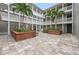 Inviting courtyard featuring brick planters with palm trees and seating for relaxing outdoors at 800 S Dakota Ave # 337, Tampa, FL 33606